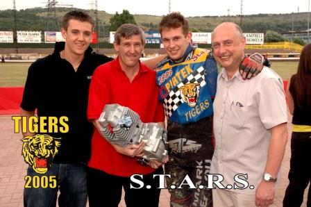 Paul Cooper receives his new GM from
Daniel Lattimer, Owen Carr and Geoff Ridsdale. Photo © Ken Carpenter